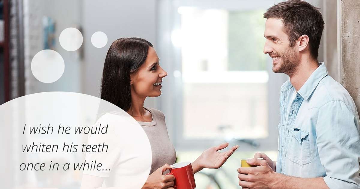 A woman trying to tell a man he should whiten his teeth