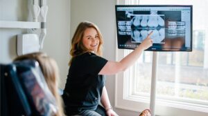 dental hygienist showing patient x-rays